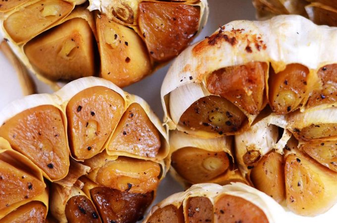 How to Roast Garlic - it really can’t get any easier than this simple recipe. Roasted garlic tastes creamy, sweet, and delish. Serve on top of toast or throw into any recipe that calls for garlic. | flipflopkitchen.com